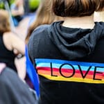 woman in black and multicolored love print hoodie
